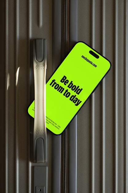 iphone screen mockup on suitcase surface, modern app presentation with travel theme