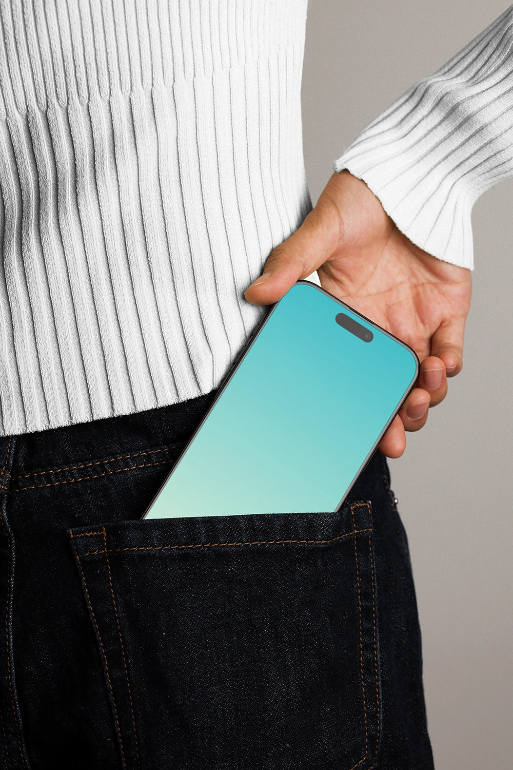 iphone screen mockup in denim pocket with hand, modern and relatable product presentation
