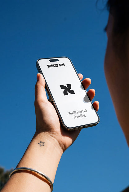 iphone mockup held in hand with blue sky background and natural sunlight realistic screen presentation