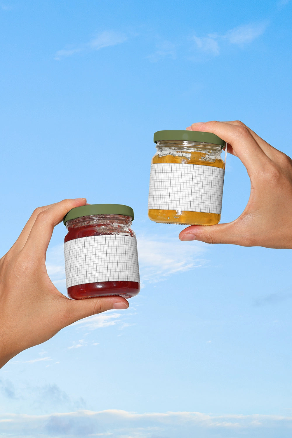Seasonal fruit jam packaging mockup with two glass jars held in air minimal aesthetic