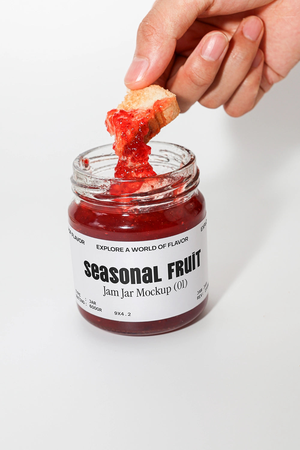 Jam jar mockup with bread dipping into red fruit jam close up food styling scene