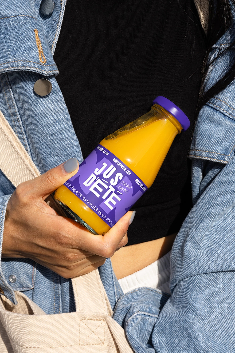 Glass juice bottle mockup close view in hand realistic outdoor beverage packaging PSD