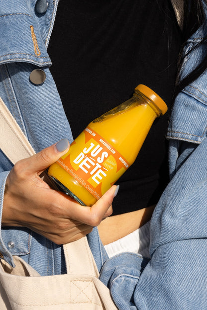 beverage bottle label mockup with juice bottle held in hand