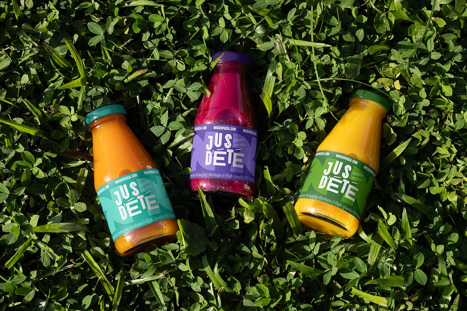 Three juice bottle mockups on green grass lifestyle organic drink presentation template