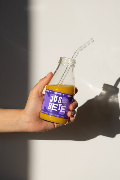 Juice bottle label mockup with clear glass bottle and drinking straw minimal shadow background
