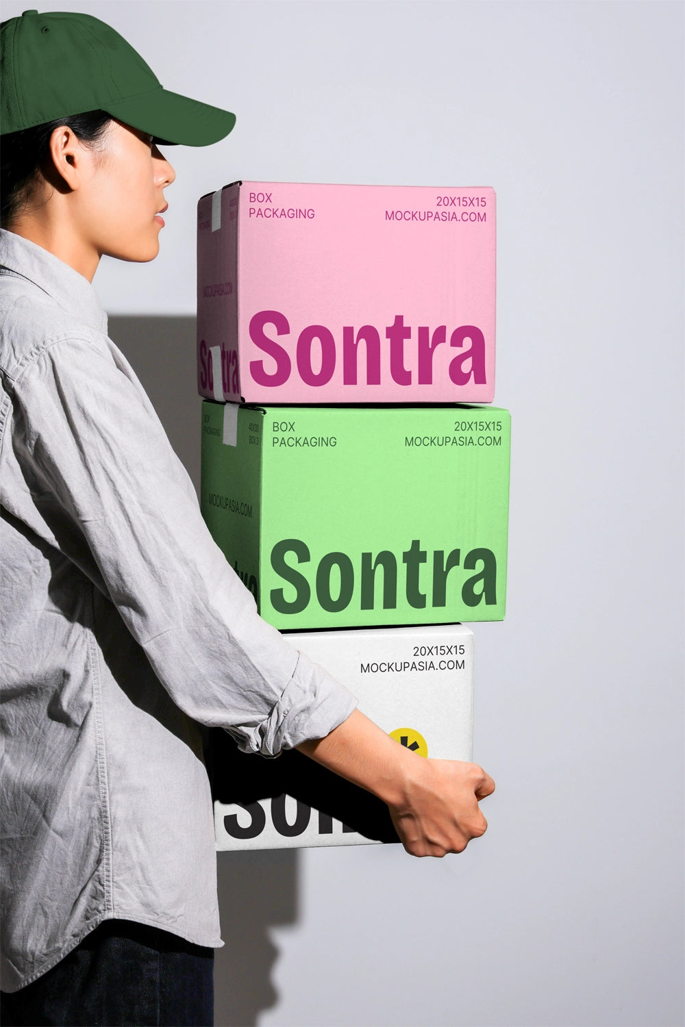 Stacked packaging box mockup with colorful cardboard boxes carried by person side view