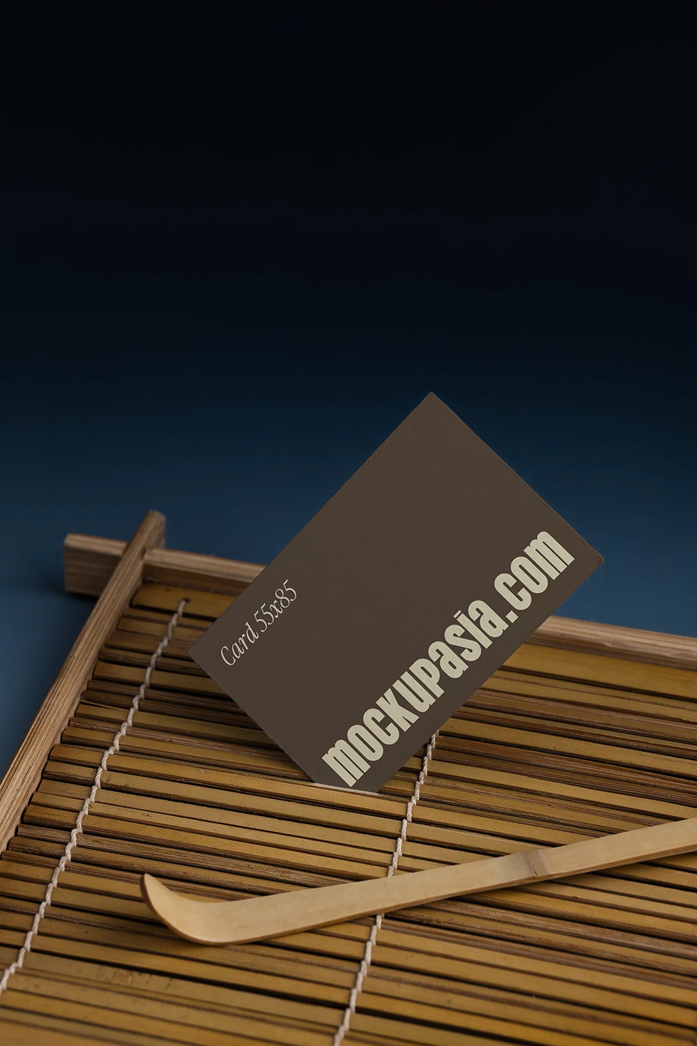 stationery card mockup with bamboo mat and tea tool, minimal studio composition