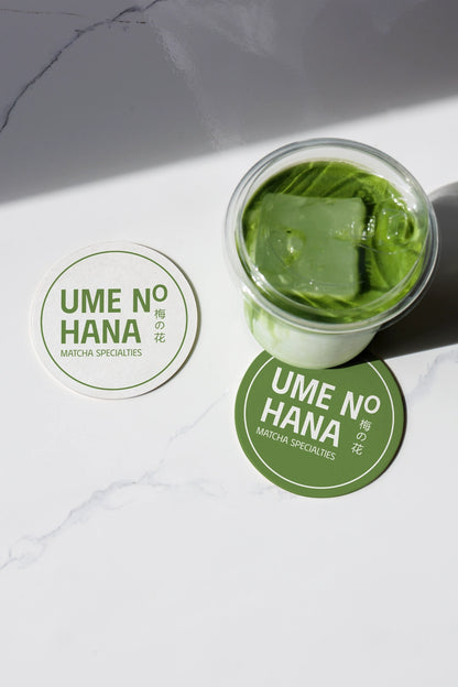 matcha beverage mockup with ice in glass jar and round label design, minimal flat lay scene