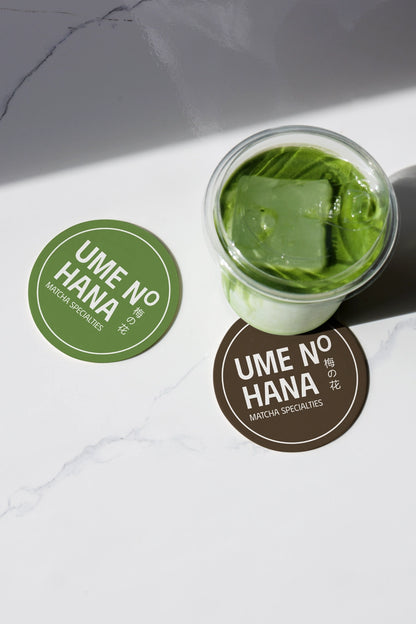 green tea matcha drink mockup with ice cubes and branding stickers, clean top view presentation