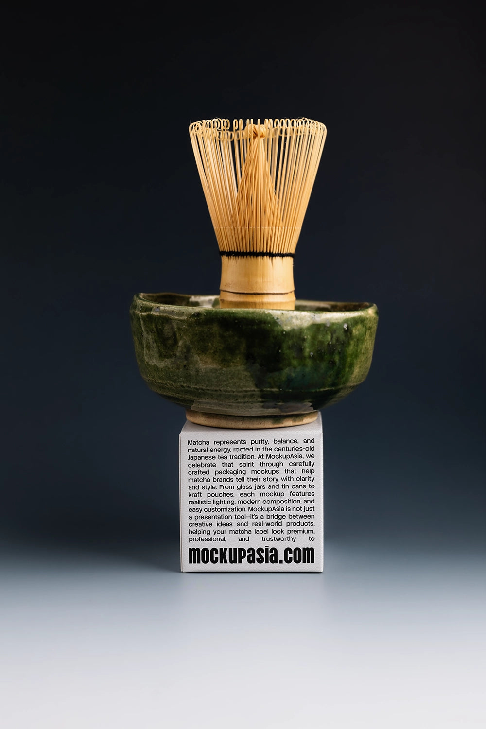 matcha packaging paper box mockup with bamboo whisk and bowl, dark studio presentation