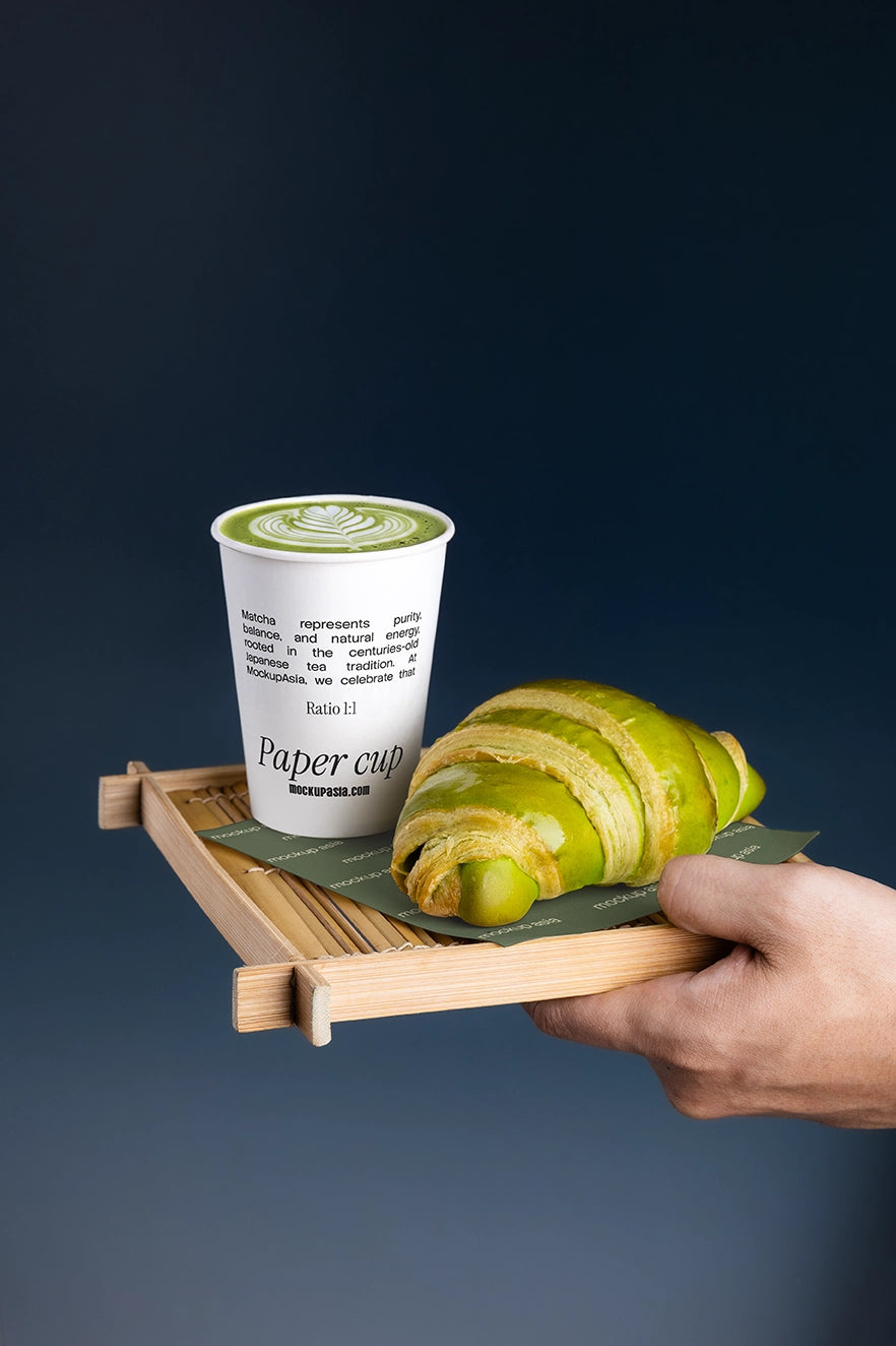 Matcha takeaway coffee cup mockup featuring editable packaging, bamboo tray, matcha latte, and bakery pastry