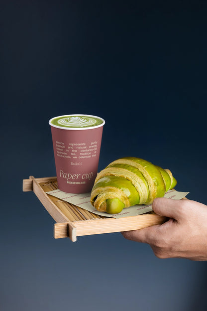 Editable matcha coffee cup mockup styled with bakery pastry and bamboo tray for cafe branding presentations