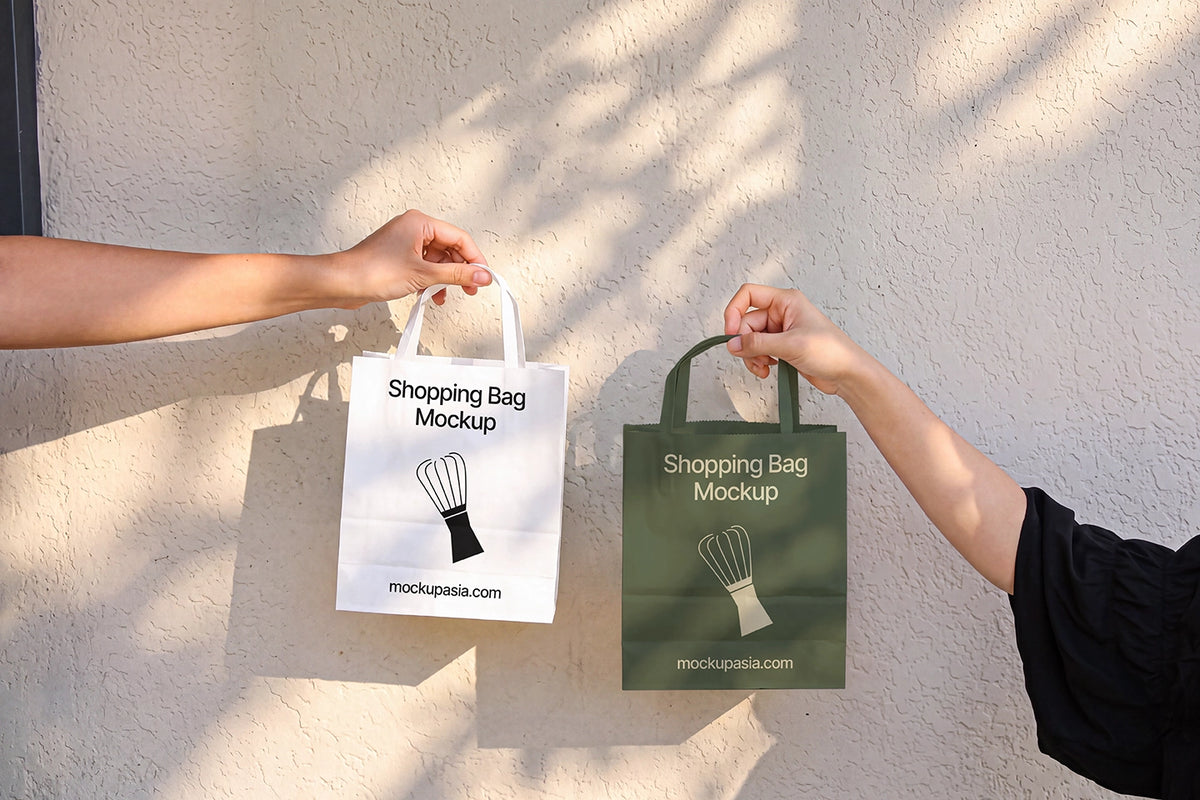 Paper shopping bag mockup PSD held by hands against sunlit wall