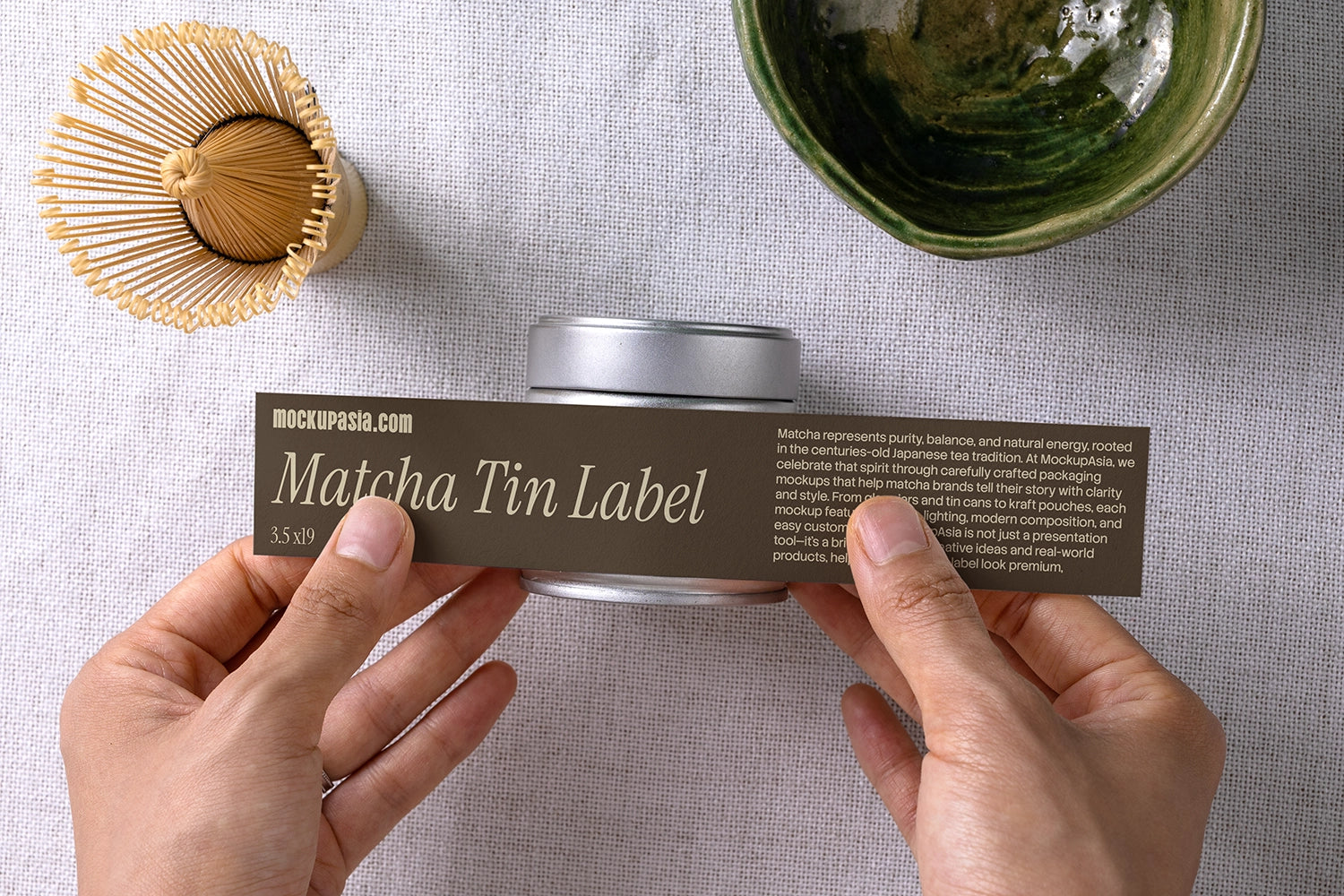 Luxury matcha packaging mockup with metal tin, bamboo whisk, and ceramic bowl in a Japanese-inspired flat lay