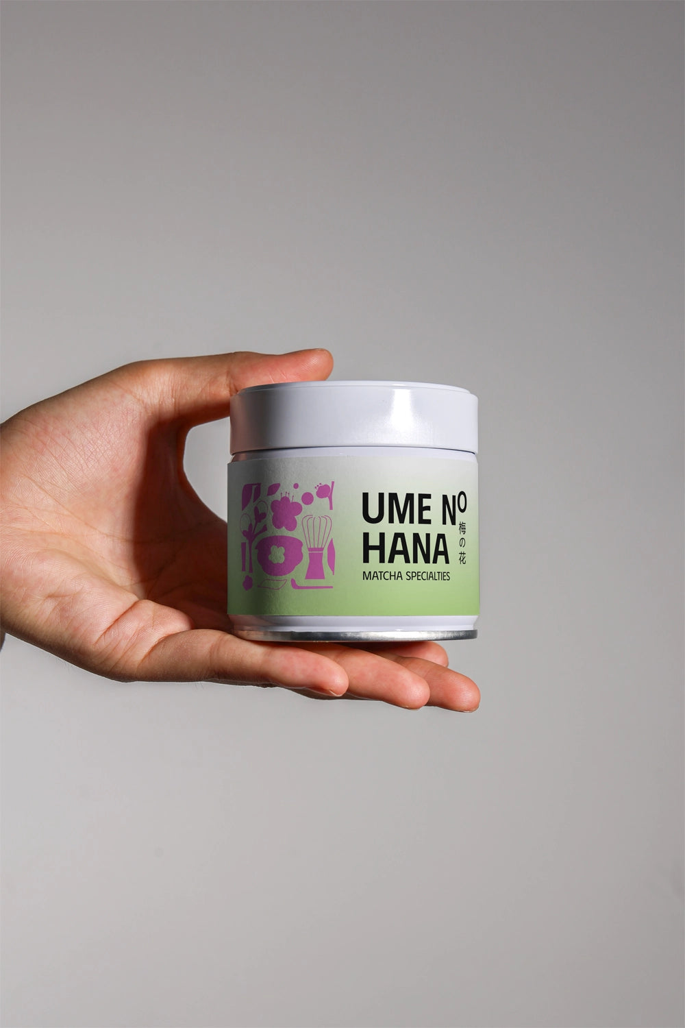 matcha jar mockup held in hand with minimal label design, clean product presentation