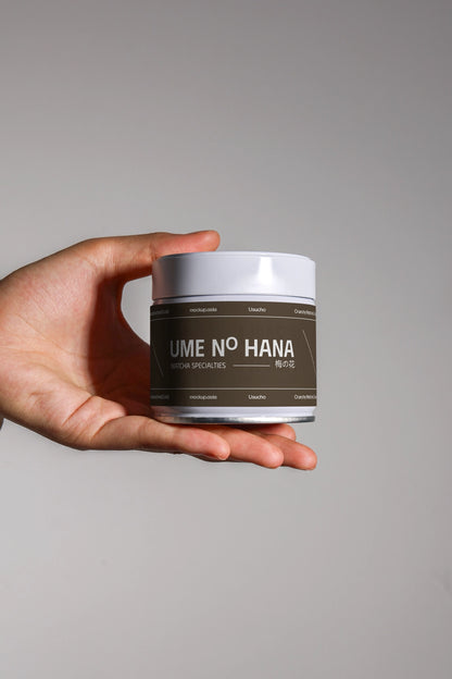 matcha tea packaging jar mockup in hand with modern branding, minimal lighting setup