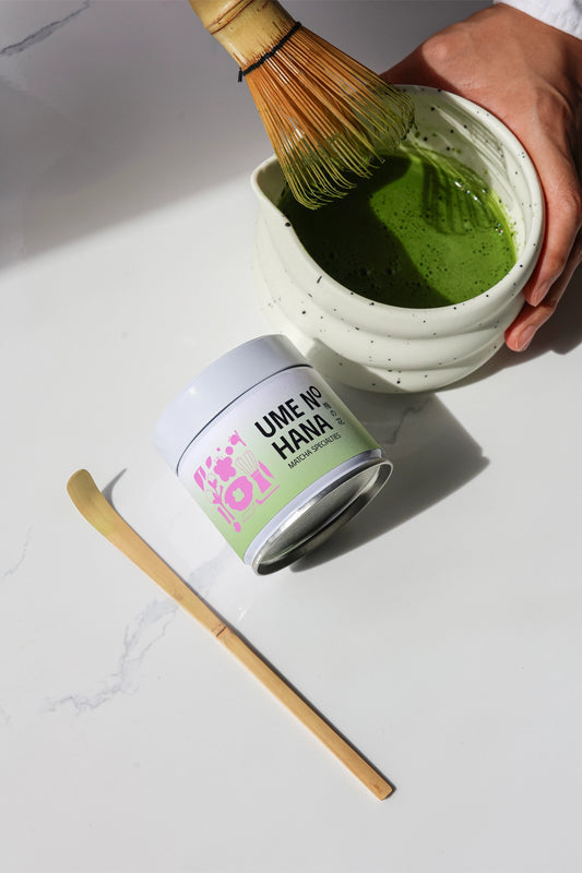 matcha preparation mockup with bamboo whisk in bowl and jar packaging, minimal lifestyle scene