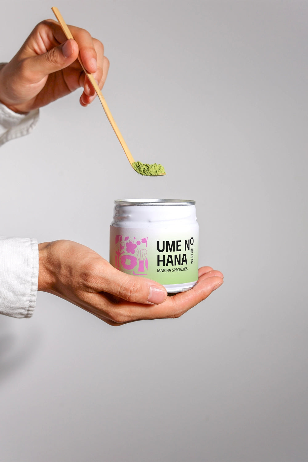 matcha jar mockup with bamboo spoon adding powder, minimal product preparation scene