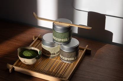 Matcha packaging mockup featuring editable metal tea tins, bamboo tray, matcha powder bowl, and Japanese tea accessories