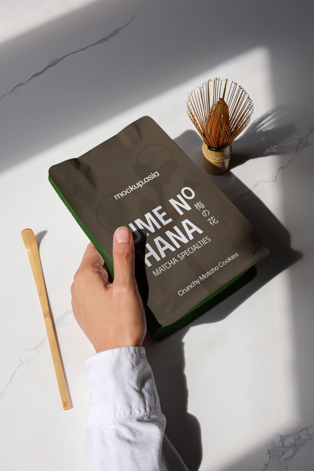green tea matcha doypack mockup with hand and tools, clean modern branding presentation