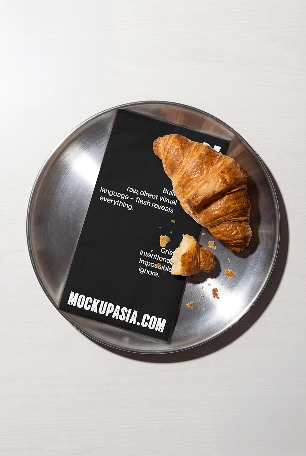 top view cafe menu paper mockup placed under croissant on stainless tray with hard flash shadows