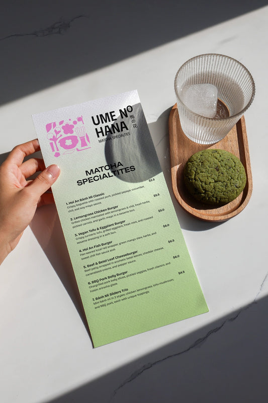 matcha menu mockup held in hand with drink and dessert, minimal flat lay branding scene