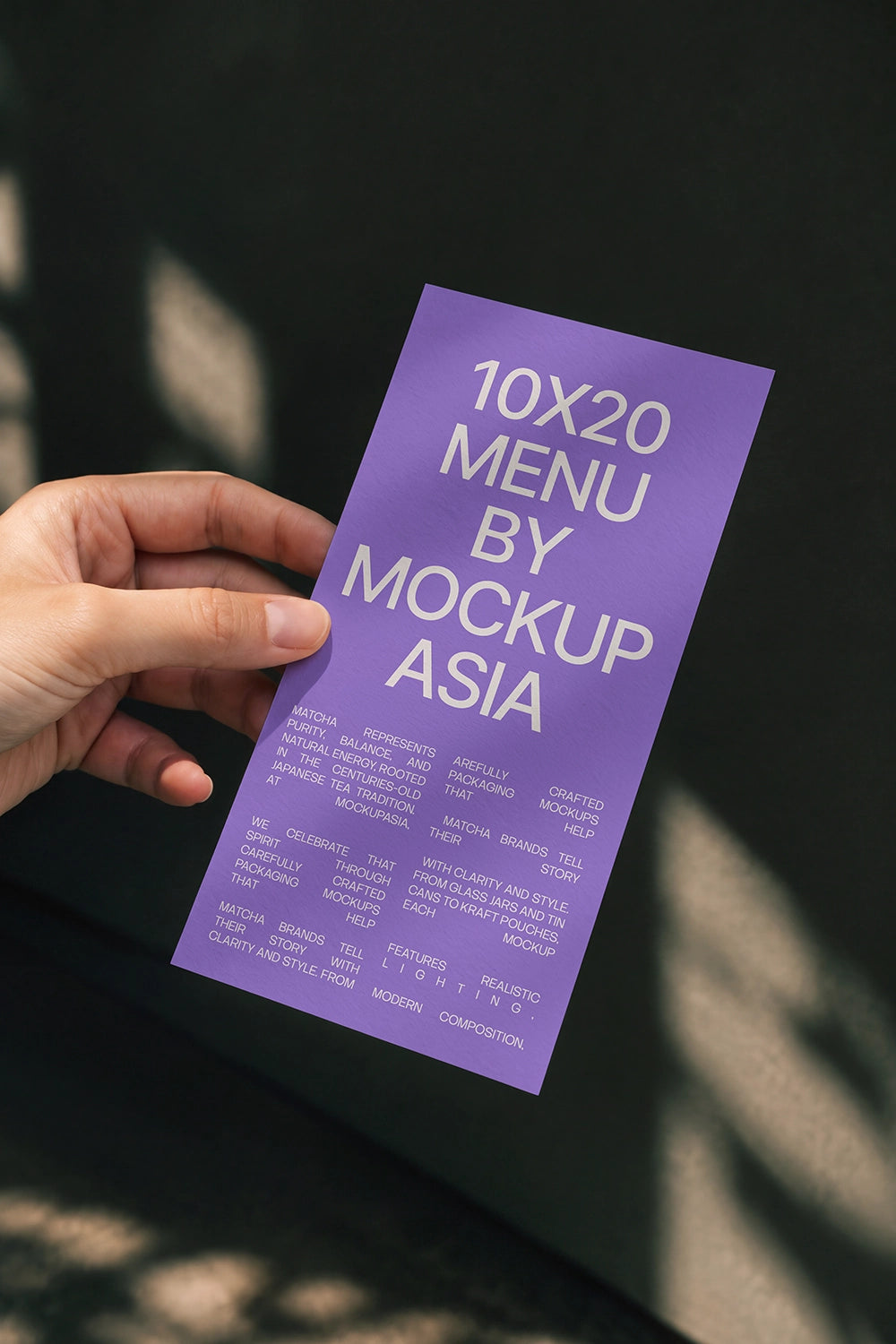 Menu card mockup PSD held in hand against dark green wall