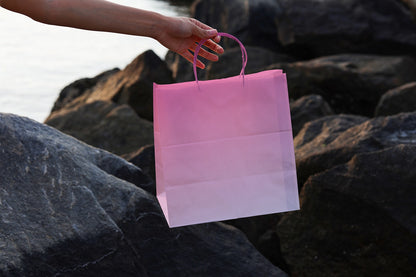 realistic shopping bag mockup outdoor with hand holding bag on stone background