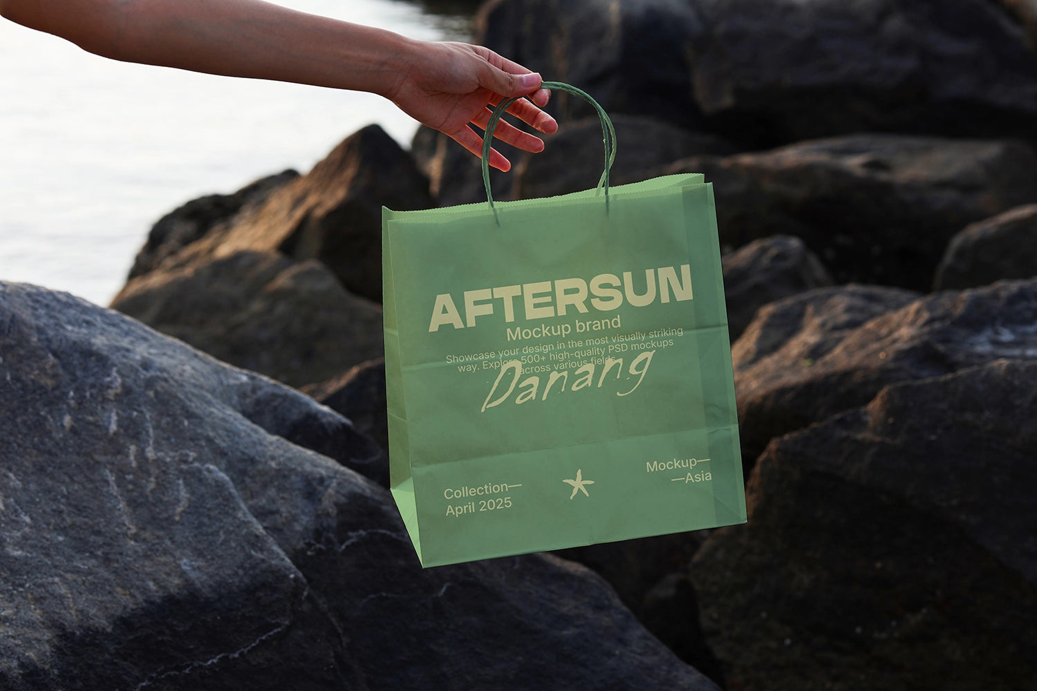 branding mockup of paper bag held over rocks with soft shadow and outdoor lighting