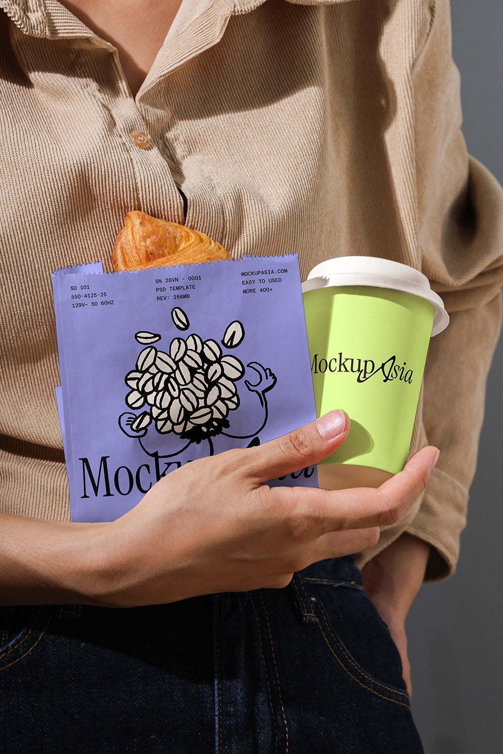 Person holding a green coffee cup and a purple product with 'Mockup Asia' branding.
