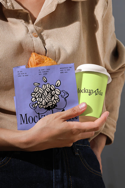 Person holding a green coffee cup and a purple product with 'Mockup Asia' branding.