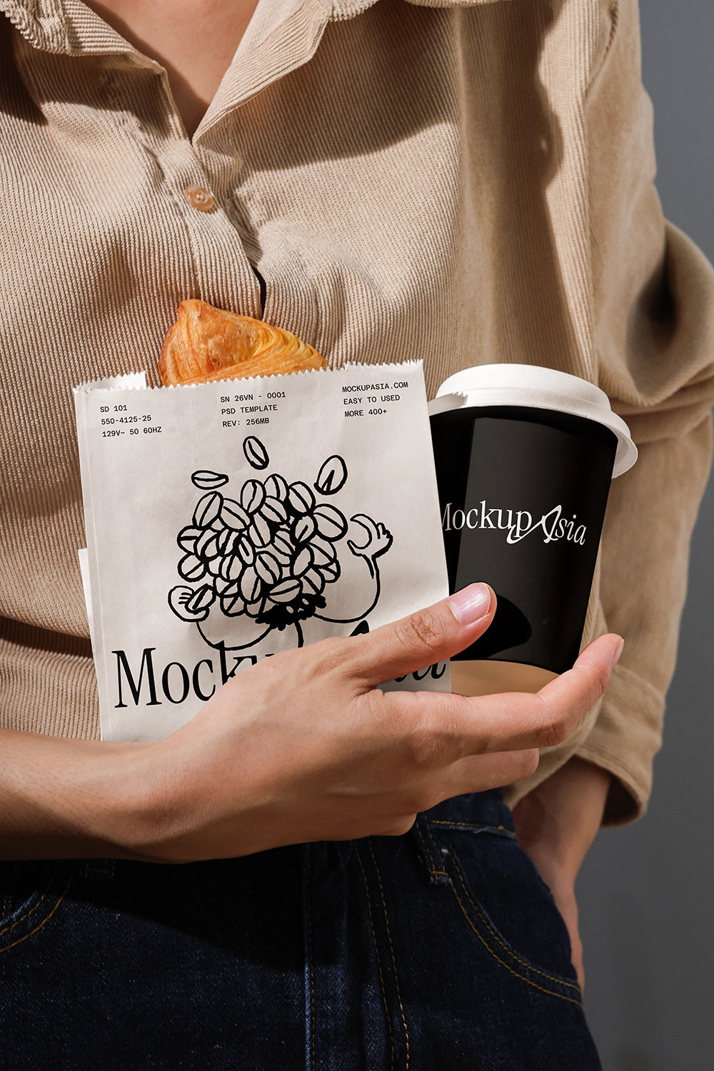 Person holding a coffee cup and pastries with 'Mockup' branding.