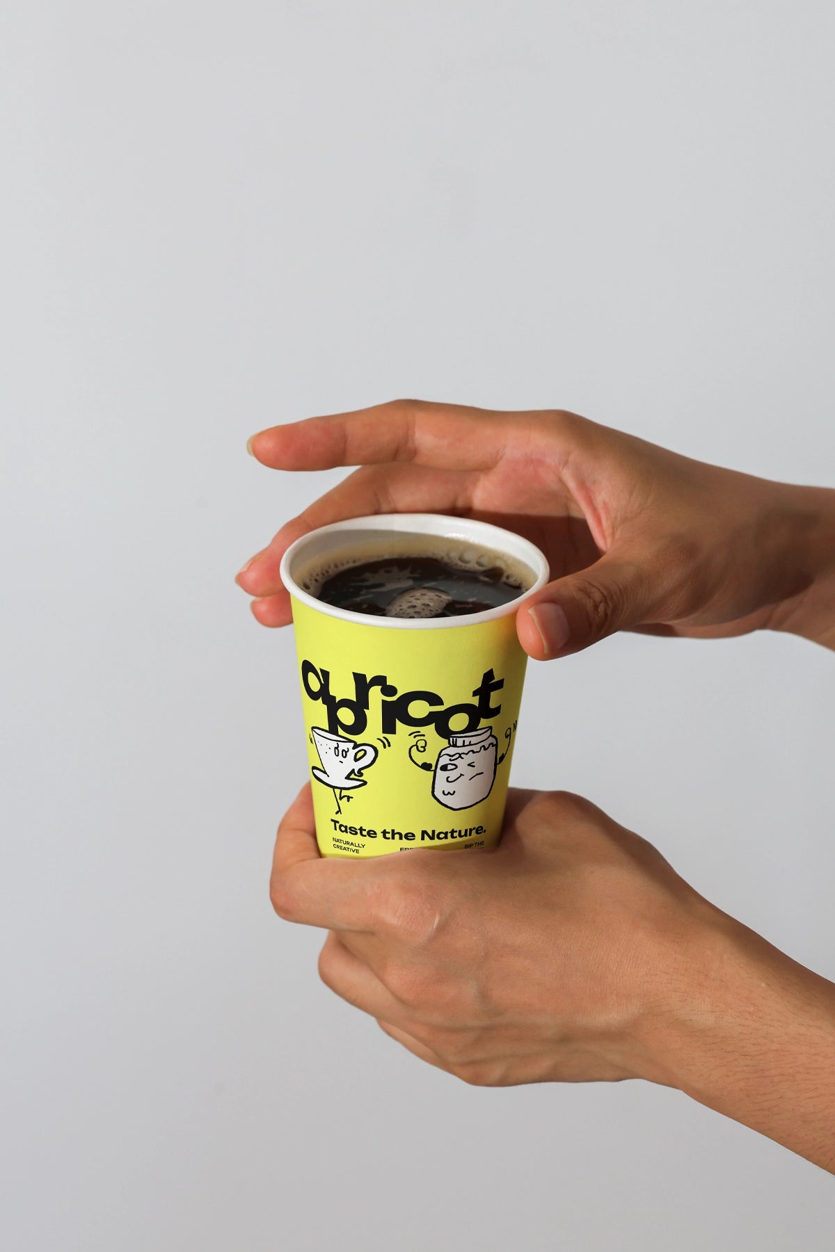 takeaway coffee cup mockup in hands with hot black coffee, clean branding presentation