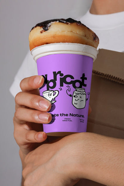 coffee cup branding mockup with pastry topping, realistic hand-held cafe packaging design