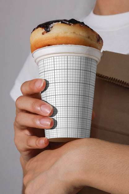 creative coffee cup mockup with pastry lid concept held in hands, modern cafe packaging template