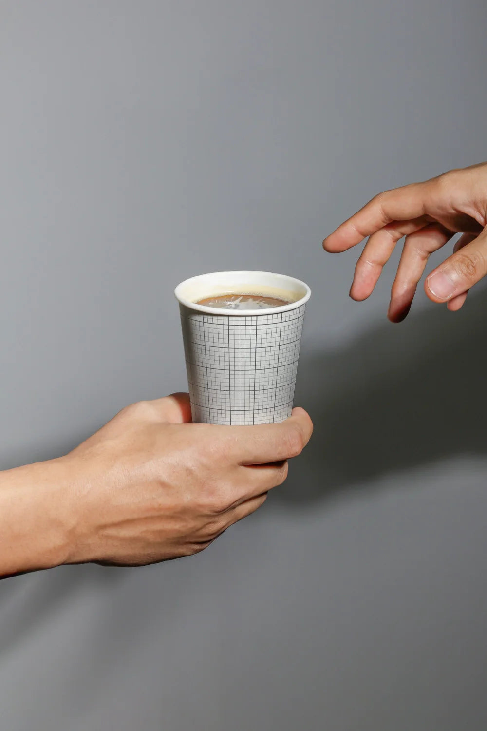 disposable paper cup mockup with hand interaction, modern minimal presentation