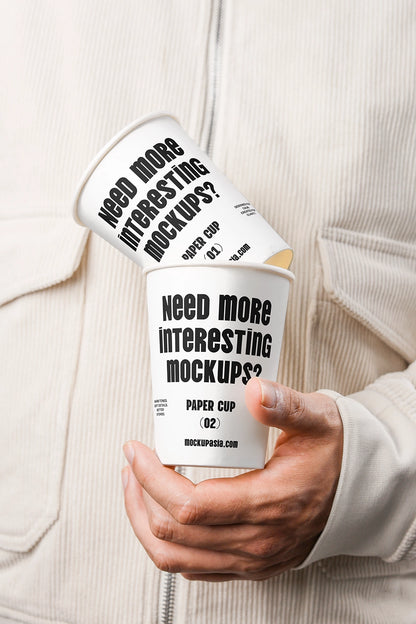paper cup mockup held in hand with stacked cups and minimal branding design