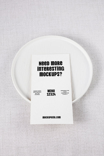 menu card mockup on ceramic plate with minimal table setting and top view