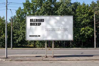 roadside billboard mockup with trees background and natural sunlight shadow patterns