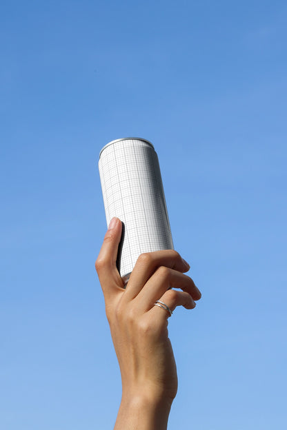 Minimal handheld soda can mockup with clean sky background for energy drink and juice packaging
