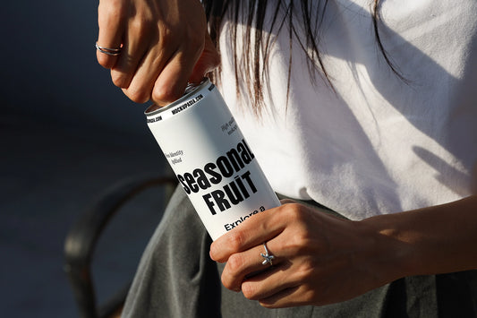 Soda can mockup with hand opening can in outdoor lifestyle setting with natural sunlight