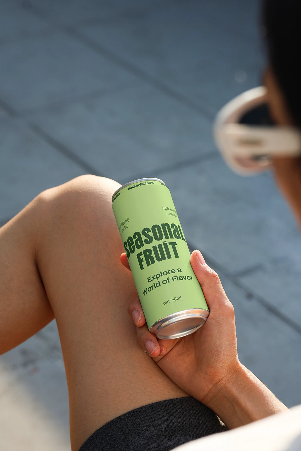 Aluminum beverage can mockup with casual handheld perspective for soda and energy drink branding