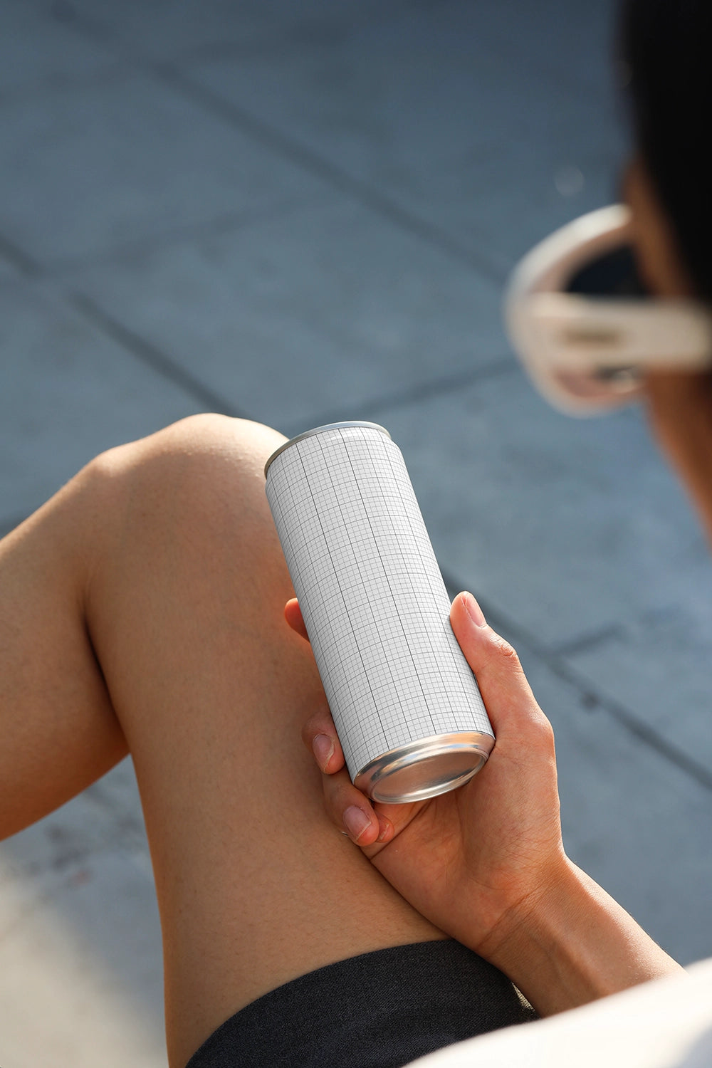 Lifestyle soda can mockup with seated position and soft natural lighting for packaging presentation