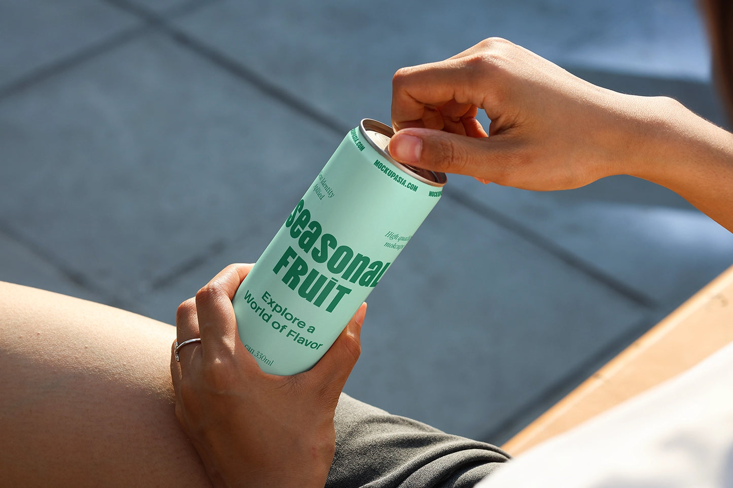 Aluminum beverage can mockup showing opening action with natural lighting for packaging presentation