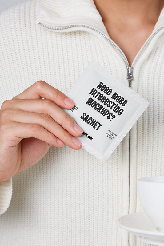 sachet mockup held in hand with minimal packaging design and clean neutral background