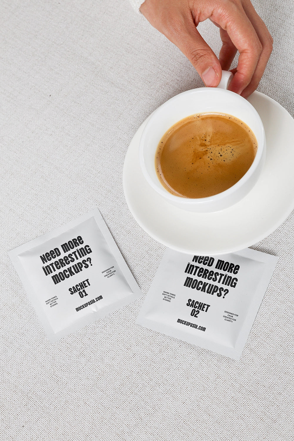sachet mockup with coffee cup top view and two packets on fabric background