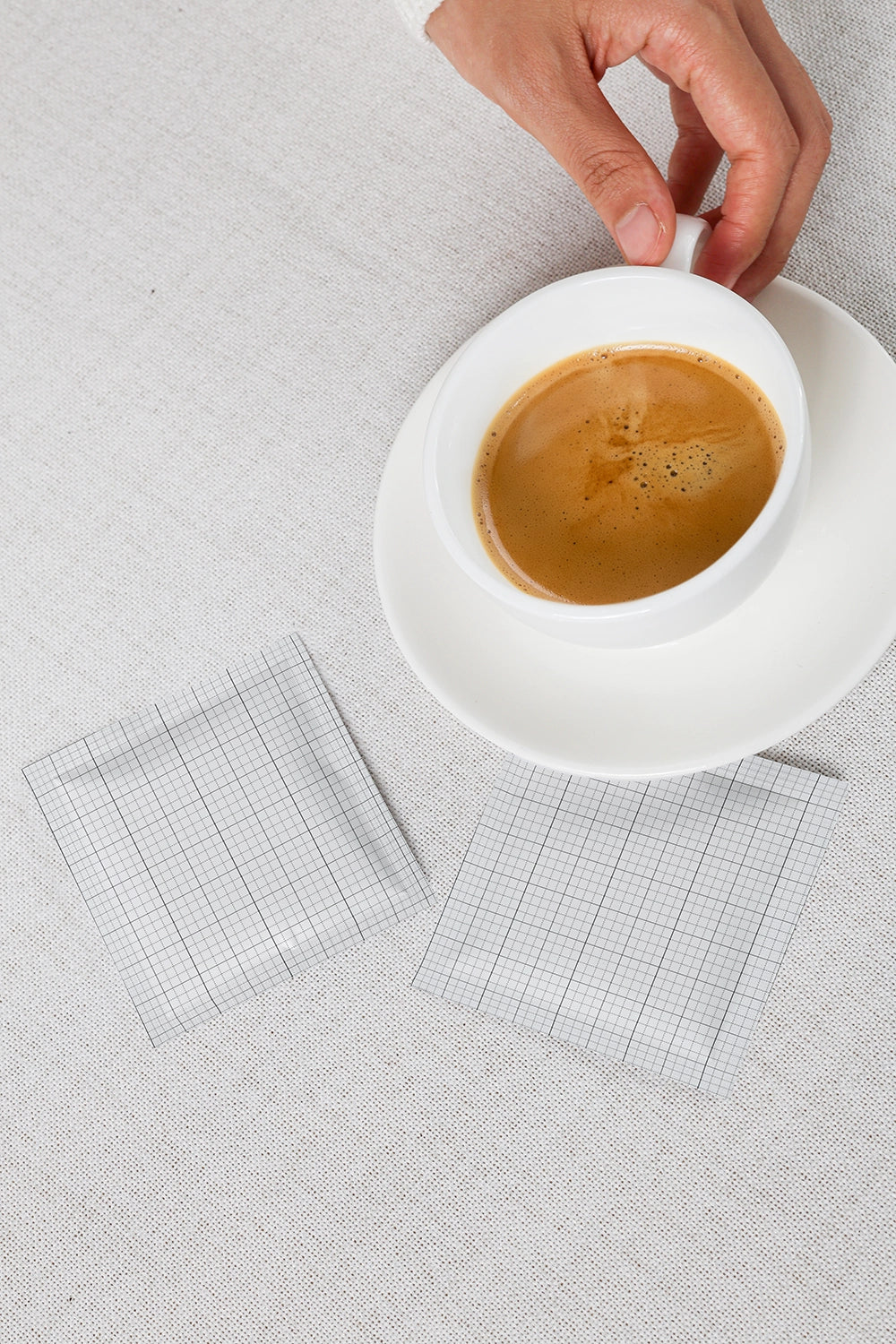 coffee sachet mockup with cup and dual packet layout on neutral textured surface