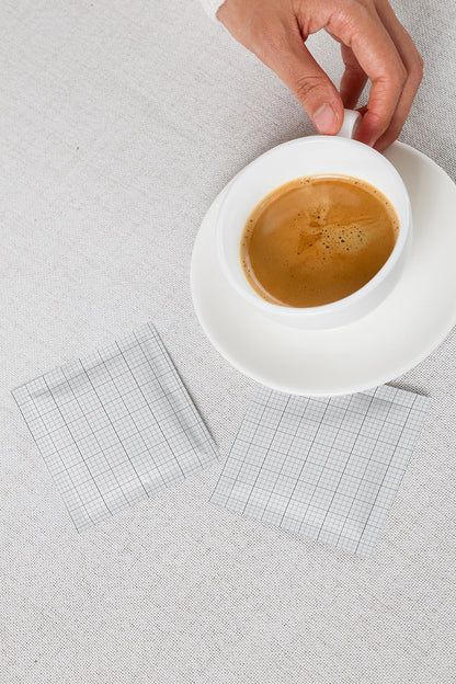coffee sachet mockup with cup and dual packet layout on neutral textured surface