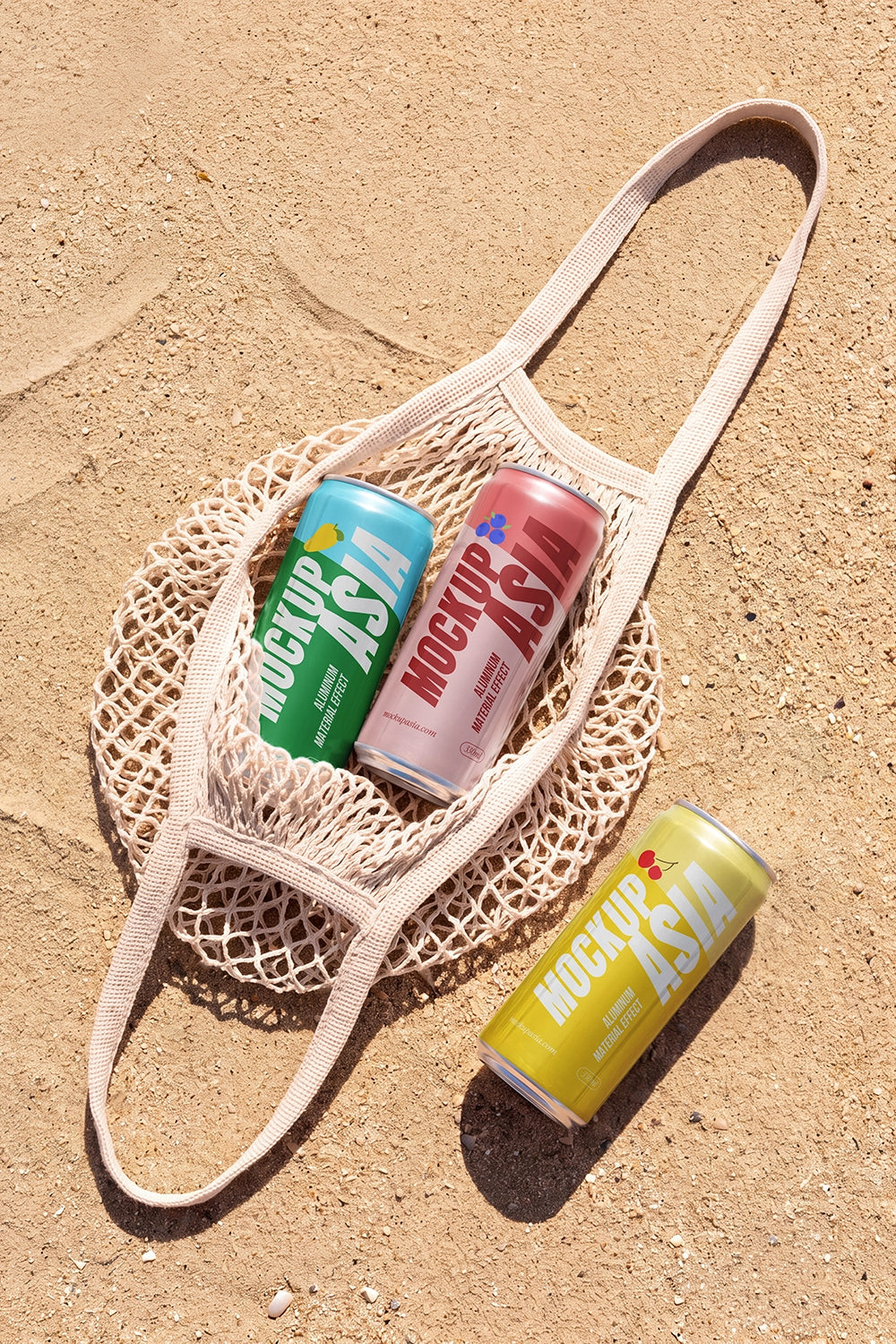 Realistic beverage cans inside a mesh bag with sandy background