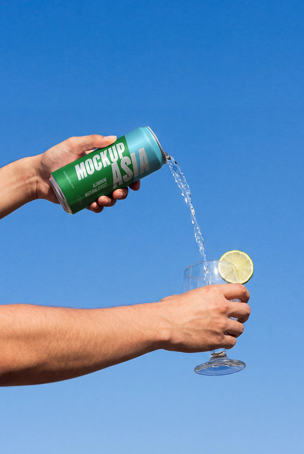 Hand holding a realistic metallic beverage can mockup with liquid pouring